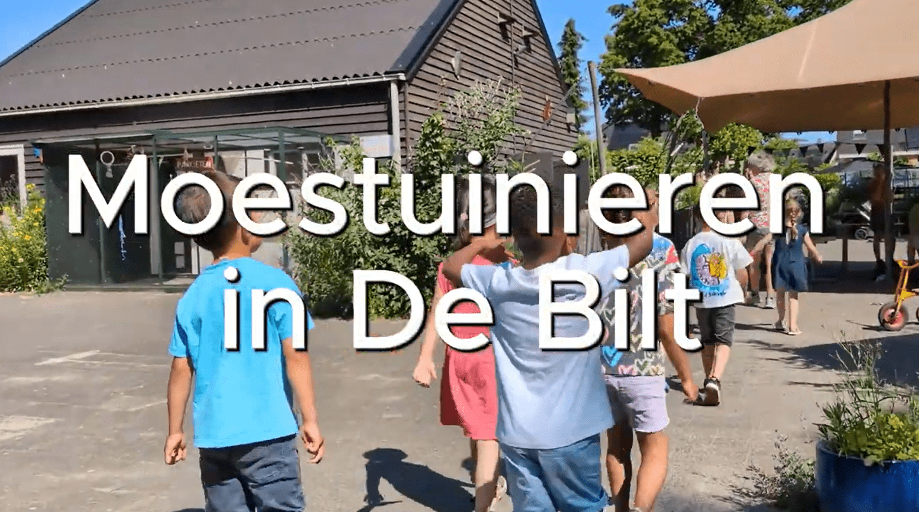 Groep kinderen bij een gebouw met de tekst 